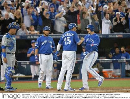 Toronto Blue Jays shortstop Troy Tulowitzki (R) celebrates with teammates after hitting a three-run home run during the third inning against the Kansas City Royals in the ALCS game 3 at the Rogers Centre in Toronto, Canada on October 19, 2015.  TOR2015101916 KEVINxDIETSCH