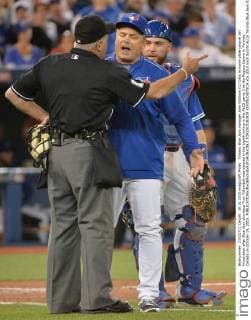 Toronto Blue Jays manager John Gibbons (C) talks to home plate umpire Joh Hirschbeck after Blue Jays shortstop Troy Tulowitzki was ejected in the eighth inning in the ALCS game 3 at the Rogers Centre in Toronto, Canada on October 19, 2015.  TOR2015101929 KEVINxDIETSCH