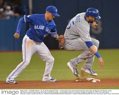Toronto Blue Jays second baseman Ryan Goins tags out Kansas City Royals runner Alex Rios at second base during the fourth in the ALCS game 4 at the Rogers Centre in Toronto, Canada on October 20, 2015. Rios was called safe but a review overturned the call.  TOR2015102028 KEVINxDIETSCH