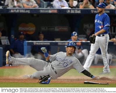 Kansas City Royals Salvador Perez (13) scores from third on sacrifice fly as Toronto Blue Jays pitcher Ryan Tepera watches the eighth inning in the ALCS game 4 at the Rogers Centre in Toronto, Canada on October 20, 2015.  TOR2015102038 KEVINxDIETSCH