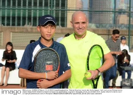 Retired American tennis star Andre Agassi, right, and young Chinese tennis player Wang Xiaofei attend a promotional event by watchmaker Longines in Shanghai, China, 21 October 2015. Agassi returns to tennis court to highlight commercial event in Shanghai  pbu348725_23