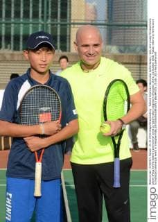 Retired American tennis star Andre Agassi, right, and young Chinese tennis player Wang Xiaofei attend a promotional event by watchmaker Longines in Shanghai, China, 21 October 2015. Agassi returns to tennis court to highlight commercial event in Shanghai  pbu348725_25