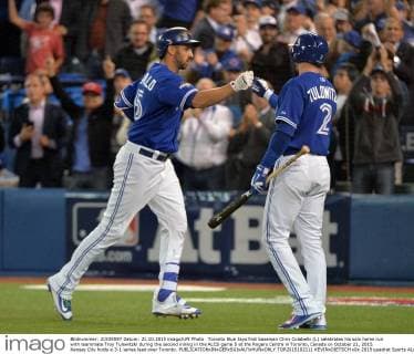 Toronto Blue Jays first baseman Chris Colabello (L) celebrates his solo home run with teammate Troy Tulowitzki during the second inning in the ALCS game 5 at the Rogers Centre in Toronto, Canada on October 21, 2015. Kansas City holds a 3-1 series lead over Toronto.  TOR2015102111 KEVINxDIETSCH