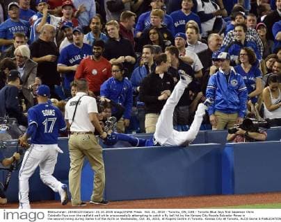 Oct. 21, 2015 - Toronto, ON, CAN - Toronto Blue Jays first baseman Chris Colabello flips over the outfield wall while unsuccessfully attempting to catch a fly ball hit by the Kansas City Royals Salvador Perez in the second inning during Game 5 of the ALCS on Wednesday, Oct. 21, 2015, at Rogers Centre in Toronto. Kansas City at Toronto, ALCS Game 5 - ZUMAm67_