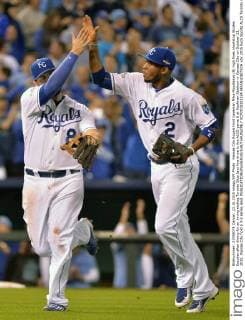 Kansas City Royals third baseman Mike Moustakas (8) high fives shortstop Alcides Escobar after diving for an inning ending Toronto Blue Jays line drive in the ALCS game 6 at Kaufman Stadium in Kansas City on October 23, 2015. Kansas City hold a 3-2 series lead.  KCP2015102324 KEVINxDIETSCH