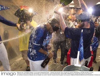 Kansas City Royals Jonny Gomes (R) pours champaign on Alcides Escobar as they celebrate in the clubhouse after the Royals won the American Leave Championship Series after defeating the Toronto Blue Jays 4-3 in game 6 at Kaufman Stadium in Kansas City on October 23, 2015. Hosmer drove home the game winning run.  KCP20151024809 KEVINxDIETSCH