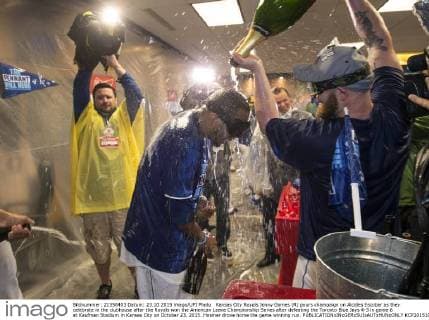 Kansas City Royals Jonny Gomes (R) pours champaign on Alcides Escobar as they celebrate in the clubhouse after the Royals won the American Leave Championship Series after defeating the Toronto Blue Jays 4-3 in game 6 at Kaufman Stadium in Kansas City on October 23, 2015. Hosmer drove home the game winning run.  KCP20151024810 KEVINxDIETSCH