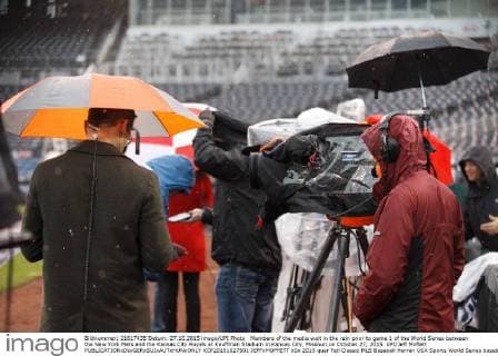 Members of the media wait in the rain prior to game 1 of the World Series between the New York Mets and the Kansas City Royals at Kauffman Stadium in Kansas City, Missouri on October 27, 2015. UPI Jeff Moffett  KCP20151027501 JEFFxMOFFETT