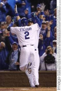 Kansas City Royals Alcides Escobar celebrates an inside the park home run on the first pitch thrown by New York Mets starting pitcher Matt Harvey with Royals Ben Zobrist in the first inning of game 1 of the World Series at Kauffman Stadium in Kansas City, Missouri on October 27, 2015.  KCP20151027204 JEFFxMOFFETT
