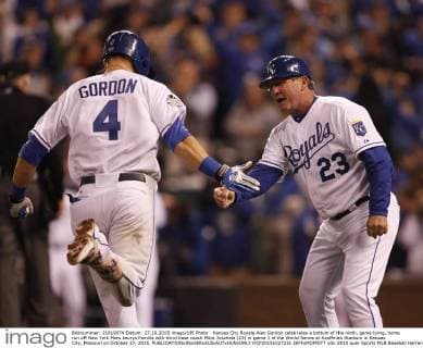 Kansas City Royals Alex Gordon celebrates a bottom of the ninth, game tying, home run off New York Mets Jeurys Familia with third base coach Mike Jirschele (23) in game 1 of the World Series at Kauffman Stadium in Kansas City, Missouri on October 27, 2015.  KCP20151027231 JEFFxMOFFETT