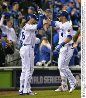 Kansas City Royals Alex Gordon (4) high fives teammate Paulo Orlando after hitting game tying solo home run against the New York Mets during the ninth inning of game 1 of the World Series at Kauffman Stadium in Kansas City, Missouri on October 27, 2015.  KCP2015102753 KEVINxDIETSCH
