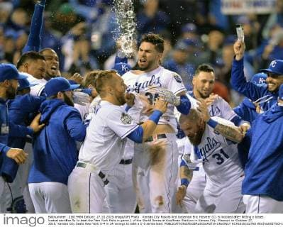 Kansas City Royals first baseman Eric Hosmer (C) is mobbed after hitting a bases loaded sacrifice fly to beat the New York Mets in game 1 of the World Series at Kauffman Stadium in Kansas City, Missouri on October 27, 2015. Kansas City beats New York 5-4 in 14 innings to take a 1-0 series lead.  KCP2015102760 KEVINxDIETSCH