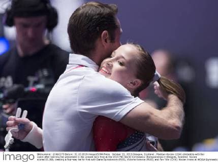 October 31, 2015 Glasgow, Scotland ..Madison Kocian (USA) celebrates with her coach after learning her placement in the uneven bars final at the 2015 FIG World Gymnastics Championships in Glasgow, Scotland. Kocian scored 15.366, creating a four-way tie for first with Daria Spirodonova (RUS), Victoria Komova (RUS), and Fan Yilin (CHN). Kocian trains at WOGA Gymnastics in Plano, Texas... GYM: 2015 FIG World Gymnastics Championships OCT 31 - ZUMAc04_