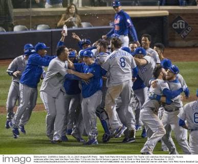 New York Mets third base coach Tim Teufel (18) watches the Kansas City Royals celebrate after they beat the New York Mets 7-2 to win the World Series in game 5 at Citi Field in New York City on November 1, 2015.  NYP20151101332 RAYxSTUBBLEBINE