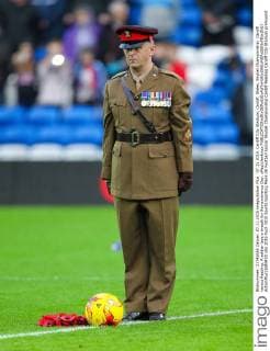 07.11.2015. Cardiff City Stadium, Cardiff, Wales. Skybet Championship. Cardiff versus Reading. A soldier lays a wreath for Remembrance Day. xPaulxJenkinsx  ActionPlus11680410