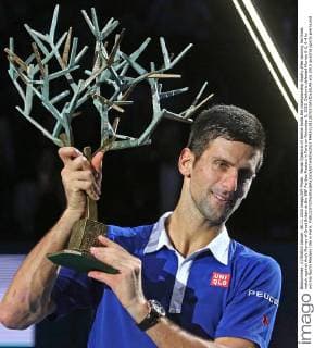 Novak Djokovic of Serbia holds the championship trophy after winning his finals match against Andy Murray of Great Britain at the BNP Paribas Masters in Paris on November 8, 2015. Djokovic defeated Murray 6-2, 6-4 to win his fourth Masters title in Paris.  PAR20151108703 DAVIDxSILPA