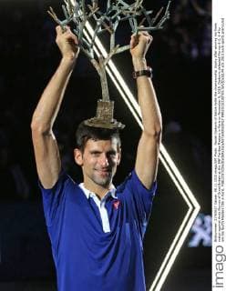 Novak Djokovic of Serbia holds the championship trophy after winning his finals match against Andy Murray of Great Britain at the BNP Paribas Masters in Paris on November 8, 2015. Djokovic defeated Murray 6-2, 6-4 to win his fourth Masters title in Paris.  PAR20151108705 DAVIDxSILPA
