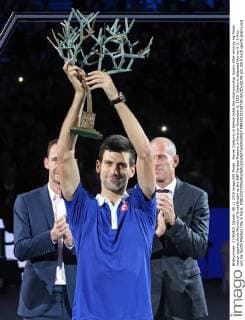 Novak Djokovic of Serbia holds the championship trophy after winning his finals match against Andy Murray of Great Britain at the BNP Paribas Masters in Paris on November 8, 2015. Djokovic defeated Murray 6-2, 6-4 to win his fourth Masters title in Paris.  PAR20151108738 DAVIDxSILPA