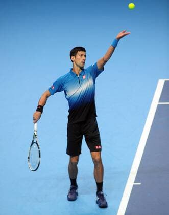 Tennis - 2015 ATP Tennis Herren World Tour Finals at The O2 - Day One Group : Stan Smith : Mens singles : Novak Djokovic (Serb) vs. Kai Nishikori (Jap) Novak Djokovic serving COLORSPORT ANDREW COWIE 