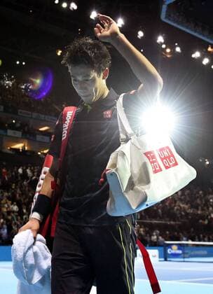 Nishikori eliminated from Tour Finals Kei Nishikori leaves the court after losing to Roger Federer in their group-stage match of the ATP Tennis Herren World Tour Finals in London on Nov. 19, 2015. Nishikori was knocked out of the tournament with a 1-2 record in the round-robin group stage. 