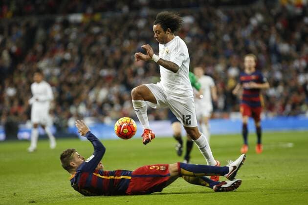 Real Madrid s Marcelo Vieira and Barcelona s Pique during 2015-16 La Liga match between Real Madrid and Barcelona at Santiago Bernabeu stadium in Madrid, Spain. November 21, 2015.  (20151121059)