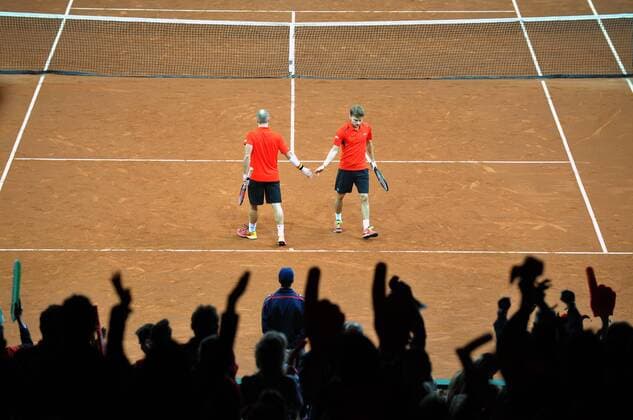 Tennis - 2015 Davis Cup by BNP Paribas - World Group Final: Belgium vs. Great Britain Day Two Rubber Three: Doubles David Goffin (Bel) and Steve Darcis (Bel) vs. Andy Murray (GB) and Jamie Murray (GB) Belgium s (left to right) Steve Darcis and David Goffin in action during the match at the Flanders Expo, Ghent. COLORSPORT JANE BARLOW 