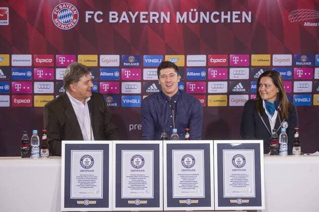 MUNICH, GERMANY - NOVEMBER 30: Robert Lewandowski (C) speaks to the media next to Guinness World Records adjudictor Seyda Subasi-Gemici and FC Bayern Muenchen media director Markus Hoerwick (L) during a press conference PK Pressekonferenz on his Guinness World records at Saebener Strasse training ground on November 30, 2015 in Munich, Germany. 