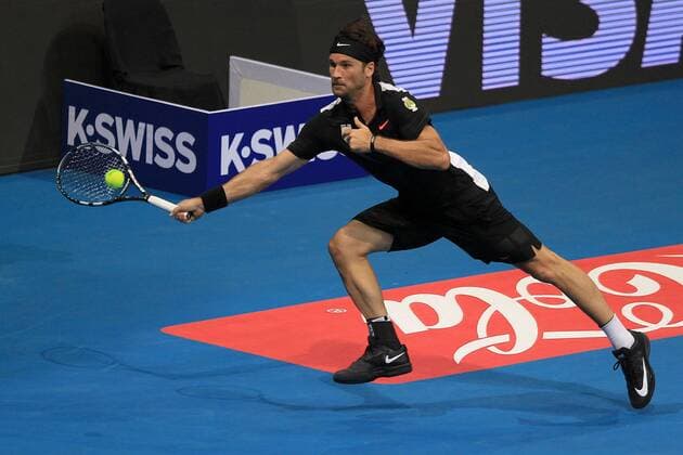 (151206) -- PASAY CITY, Dec. 6, 2015 -- Spanish player Carlos Moya of Singapore Slammers returns the ball against Russian player Marat Safin of Japan Warriors during their match in the International Premier Tennis League (IPTL) in Pasay City, the Philippines, Dec. 6, 2015. Carlos Moya won 6-4. ) (SP)PHILIPPINES-PASAY CITY-TENNIS-IPTL RouellexUmali 