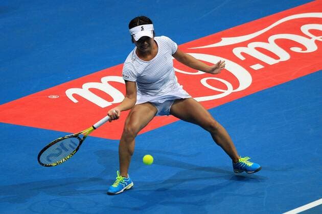 (151206) -- PASAY CITY, Dec. 6, 2015 -- Japan Warriors player Kurumi Nara of Japan returns the ball against Singapore Slammers player Belinda Bencic of Switzerland during the women s singles match in the International Premier Tennis League (IPTL) in Pasay City, the Philippines, Dec. 6, 2015. Kurumi Nara lost 2-6. ) (SP)PHILIPPINES-PASAY CITY-TENNIS-IPTL RouellexUmali 