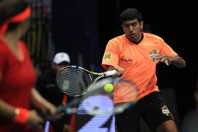 (151207) -- PASAY CITY, Dec. 7, 2015 -- Micromax Indian Aces player Rohan Bopanna (R) of India returns the ball against players of the Obi UAE Royals during their mixed doubles match in the International Premier Tennis League (IPTL) in Pasay City, the Philippines, Dec. 7, 2015. Micromax Indian Aces won 6-4. ) (SP)PHILIPPINES-PASAY CITY-TENNIS-IPTL-MEN S DOUBLES ROUELLExUMALI 