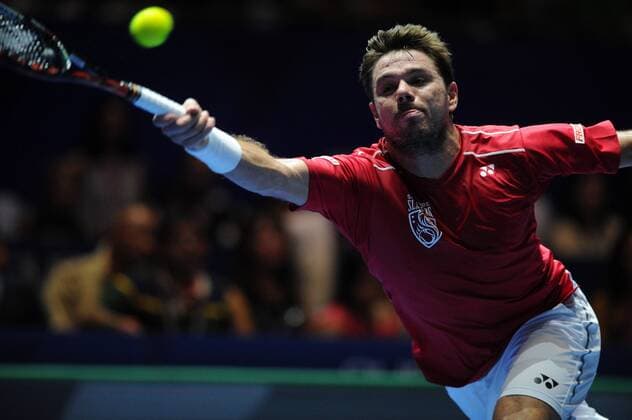 Switzerland s player Stan Wawrinka of OUE Singapore Slammers returns the ball to Switzerland s player Roger Federer of OBI UAE Royals during the International Premier Tennis League (IPTL) men s singles set held in Singapore Indoor Stadium on Dec. 18, 2015. Roger Federer won 6-4.) (SP)SINGAPORE-TENNIS-IPTL ThenxChihxWey 