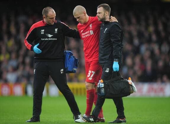 Football - 2015 2016 Premier League - Watford vs. Liverpool Martin Skrtel of Liverpool leaves the field injured at Vicarage Road, with physios Andrew Massey, left, and Chris Morgan. COLORSPORT ANDREW COWIE 