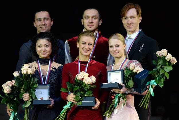 YEKATERINBURG, RUSSIA. DECEMBER 27, 2015. Silver medallists Yuko Kavaguti (front L) and Alexander Smirnov (back L), gold medal winners Tatyana Volosozhar (front C) and Maxim Trankov (back C), and bronze medallists Yevgenia Tarasova (front R) and Yevgeny Morozov (back R) pose for a group photograph during the medal ceremony for the pairs Figure skating Eiskunstlauf competition at the 2015 2016 Russian Figure Skating Championships. Donat Sorokin TASS  TS014B9B