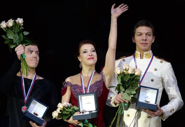 YEKATERINBURG, RUSSIA. DECEMBER 27, 2015. Silver medallist Nikita Katsalopov, and gold medal winners Yekaterina Bobrova and Dmitry Solovyev (L-R) during the medal ceremony for the pairs Ice dancing Eistanzen competition at the 2015 2016 Russian Figure skating Eiskunstlauf Championships. Donat Sorokin TASS  TS014B99