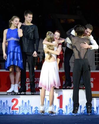YEKATERINBURG, RUSSIA. DECEMBER 27, 2015. Silver medallists Viktoria Sinitsina and Nikita Katsalapov (from L) look on as bronze medallists Alexandra Stepanova (C front) and Ivan Bukin (R front) hug gold medal winners Yekaterina Bobrova (C back) and Dmitry Solovyev (R back) during the medal ceremony for the pairs Ice dancing Eistanzen competition at the 2015 2016 Russian Figure skating Eiskunstlauf Championships. Donat Sorokin TASS  TS014B94