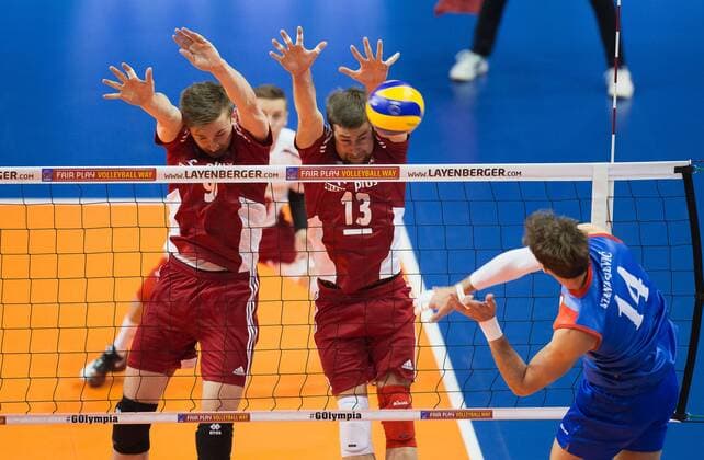 Berlin, Deutschland, 05.01.2016: Volleyball Olympia Qualifikation Männer Maenner 2016 - Spiel 3 Serbien - Polen. Aleksandar Atanasijevic (Serbia 14) against Mateusz Bieniek (Poland 9) and Michal Kubiak (Poland 13)