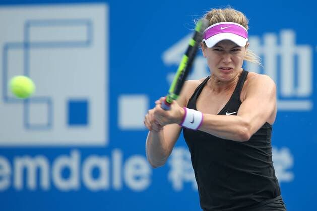 SHENZHEN, CHINA - JANUARY 07: (CHINA OUT) Eugenie Bouchard of Canada returns a shot against Timea Babos of Hungary in quarter finals match during Day five of 2016 WTA Tennis Damen Shenzhen Open at Longgang Sports Center on January 7, 2016 in Shenzhen, Guangdong Province of China.  CFP477886446 