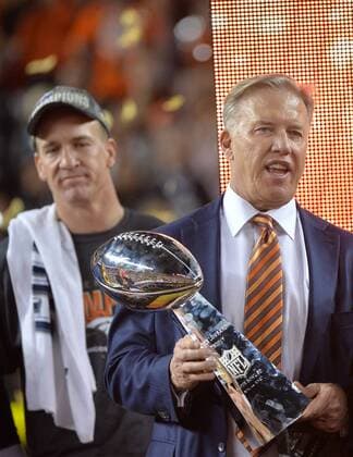 Denver Broncos executive John Elway (R) holds the Lombardi trophy with quarterback Peyton Manning in the background at Super Bowl 50 at Levi s Stadium in Santa Clara, California on February 7, 2016. Denver wins Super Bowl 50 defeating Carolina 24-10.  SBP20160207496 KEVINxDIETSCH