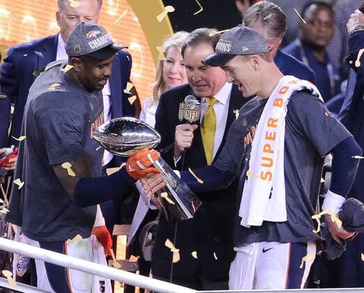 MVP Denver Broncos Von Miller (L) hands the Vince Lombardi Trophy to QB Peyton Manning after Super Bowl 50 in Santa Clara, California on February 7, 2016. The Denver Broncos defeated the Carolina Panthers 24-10.  SBP20160207093 KHALEDxSAYED