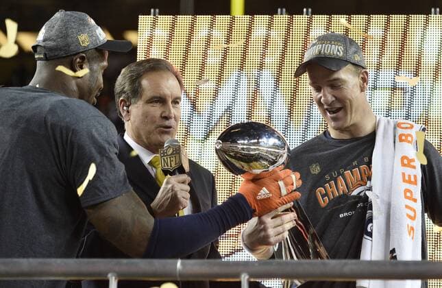 MVP Denver Broncos Von Miller (L) hands the Lombardi Trophy to QB Peyton Manning after Super Bowl 50 in Santa Clara, California on February 7, 2016. The Denver Broncos defeated the Carolina Panthers 24-10.  SBP20160207098 BRIANxKERSEY