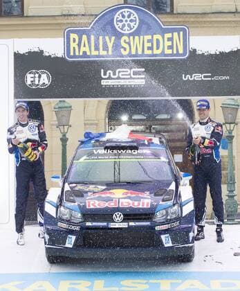 Motorsport, WRC, Rallye Schweden, Siegerehrung 160214 Sebastien Ogier med kartläsare Julien Ingrassia , (Volkswagen Motorsport, Volkswagen Polo WRC Motorsport Rallye WM sprutar champagne och jublar efter segern vid prisutdelningen under Rally Sweden den 14 februari 2016 i Karlstad.  Copyright: ANNA-LENAxBERGQVIST BB160214BB902