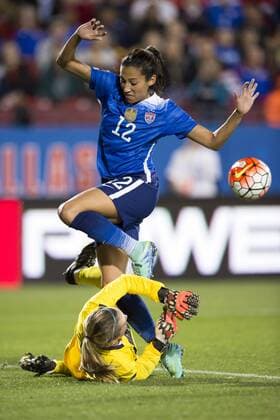 February 15, 2016: United States forward Christen Press (12) jumps over Puerto Rico goalkeeper Karly Gustafson (1) after Gustafson blocked her shot on goal during the match between the United States and the Puerto Rico during the CONCACAF 2016 Olympic Qualifying Championship at Toyota Stadium, in Frisco, Texas. The US defeated Puerto Rico 10-0. Soccer 2016: United States vs Puerto Rico FEB 15 - ZUMAc04_