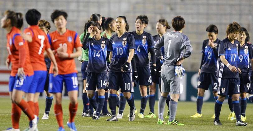 Soccer: Japan in danger of missing out on Rio after draw with S. Korea Members of the Japanese women s soccer team (in navy blue) react after a 1-1 draw with South Korea at Kincho Stadium in Osaka in an Asian final qualifier for the Rio de Janeiro Olympics on March 2, 2016. The result left Japan in fifth place on just one point from two matches in the six-team, round-robin qualifying tournament. 