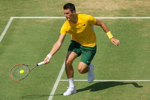 (160306) -- MELBOURNE, Mar. 6, 2016 -- Bernard Tomic of Australia returns the ball during his men s singles match against John Isner of USA during Davis Cup by BNP Paribas World Group first round tie between Australia and USA at Kooyong Lawn Tennis Club in Melbourne, Australia, Mar. 6, 2016. John Isner won 3-1, making USA won Australia with 3-1. ) (SP)AUSTRALIA-MELBOURNE-TENNIS-DAVIS CUP BaixXue 