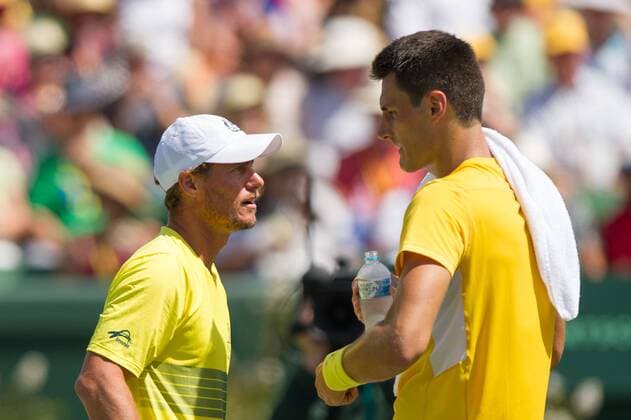 (160306) -- MELBOURNE, Mar. 6, 2016 -- Australian Davis Cup captain Lleyton Hewitt (L) speaks to Bernard Tomic during the men s singles match between Bernard Tomic and John Isner of USA during Davis Cup by BNP Paribas World Group first round tie between Australia and USA at Kooyong Lawn Tennis Club in Melbourne, Australia, Mar. 6, 2016. John Isner won 3-1, making USA won Australia with 3-1. ) (SP)AUSTRALIA-MELBOURNE-TENNIS-DAVIS CUP BaixXue 