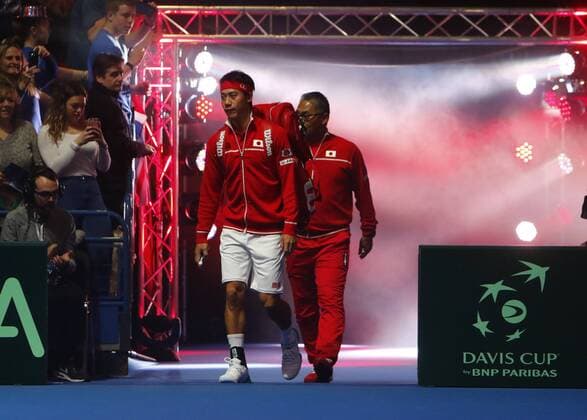 06.03.2016. Barclaycard Arena, Birmingham, England. Davis Cup Tennis World Group First Round. Great Britain versus Japan. Kei Nishikori and Japan team captain Minoru Ueda enter the court for his match against Andy Murray. xAlanxMartinx  ActionPlus11715058