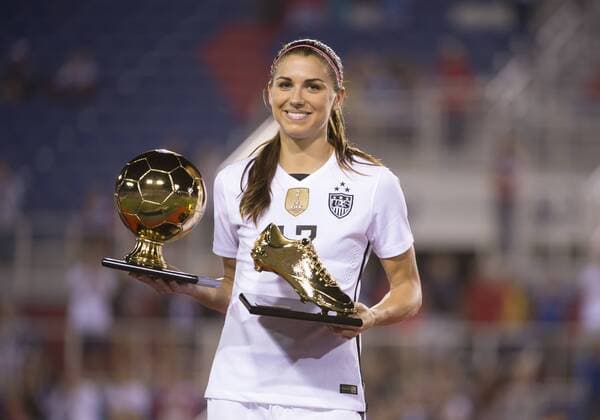 09 March 2016: United States Forward Alex Morgan (13) smiles and holds the Golden Ball and Golden Shoe trophies after USA won the SheBelieves Cup soccer match against Germany at the FAU Stadium in Boca Raton, Florida. (Photo by Doug Murray Icon Sportswire) SOCCER: MAR 09 Women s - SheBelieves Cup - USA v Germany Icon796160309009 EDITORIAL USE ONLY