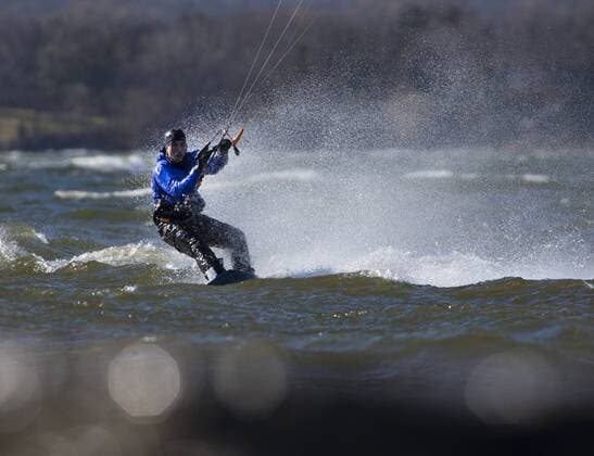 March 16, 2016 - Hamilton, ON, CAN - Kristian Wolf, 29, of Burlington, takes advantage of the warmer weather and high afternoon winds to kite board on Hamilton Harbour in Hamilton, Ontario on March 16, 2016. Kite Boarding Hamilton Harbour - ZUMAp131