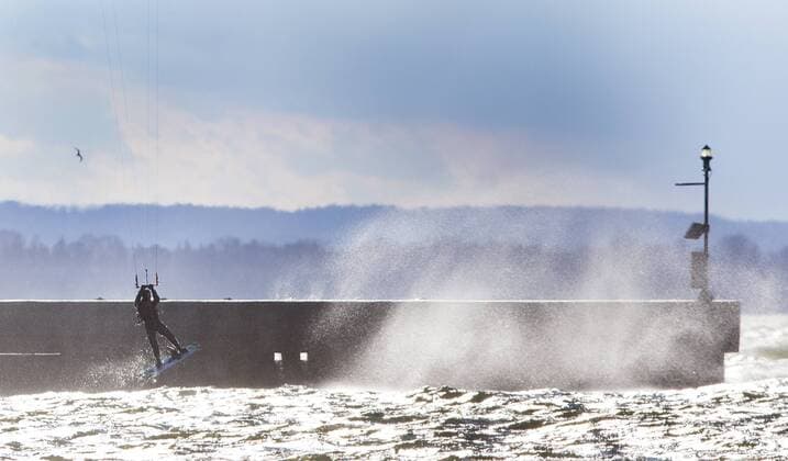 March 16, 2016 - Hamilton, ON, CAN - Kristian Wolf, 29, of Burlington, takes advantage of the warmer weather and high afternoon winds to kite board on Hamilton Harbour in Hamilton, Ontario on March 16, 2016. Kite Boarding Hamilton Harbour - ZUMAp131