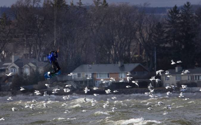 March 16, 2016 - Hamilton, ON, CAN - Kristian Wolf, 29, of Burlington, takes advantage of the warmer weather and high afternoon winds to kite board on Hamilton Harbour in Hamilton, Ontario on March 16, 2016. Kite Boarding Hamilton Harbour - ZUMAp131